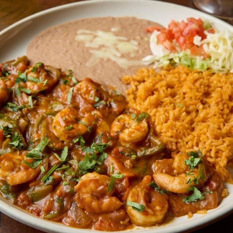 My Taco House's shrimp in red sauce with rice, refried beans, and a side salad.